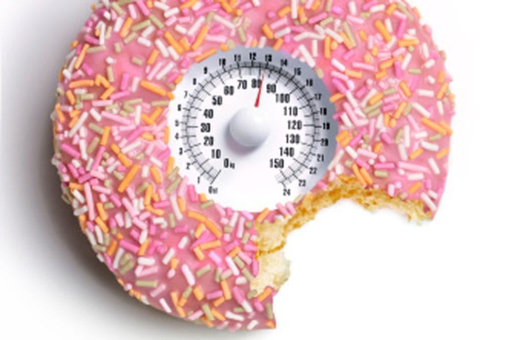 Doughnut with bite out and weighing scales