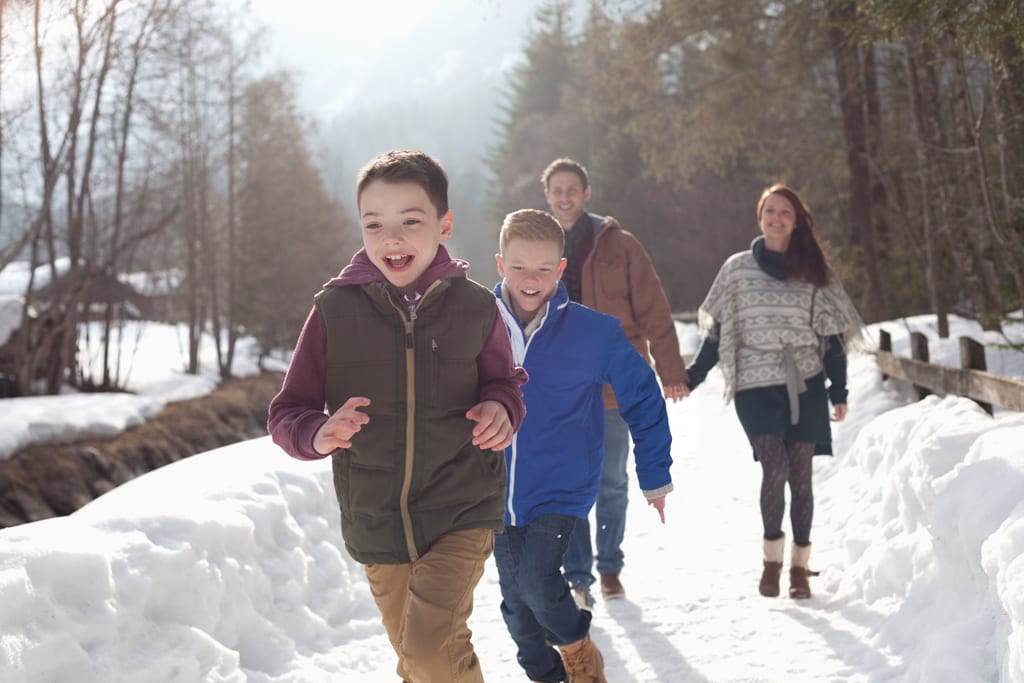 Family fitness - family playing in snow