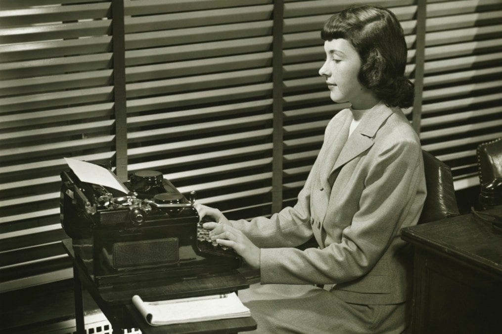 woman using typewriter