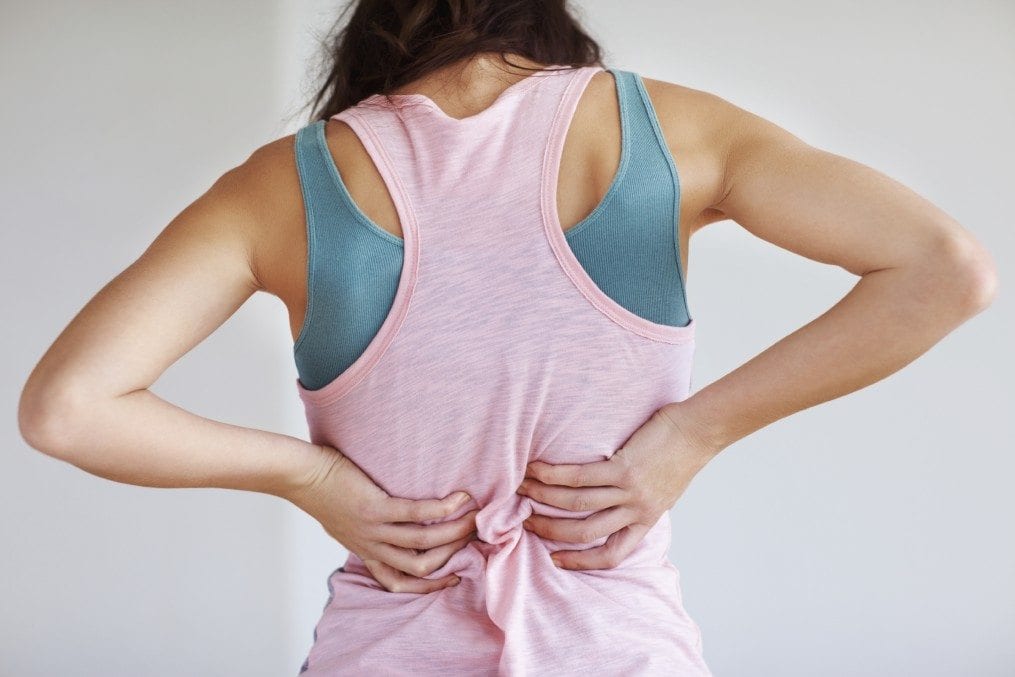 young woman suffering from back pain
