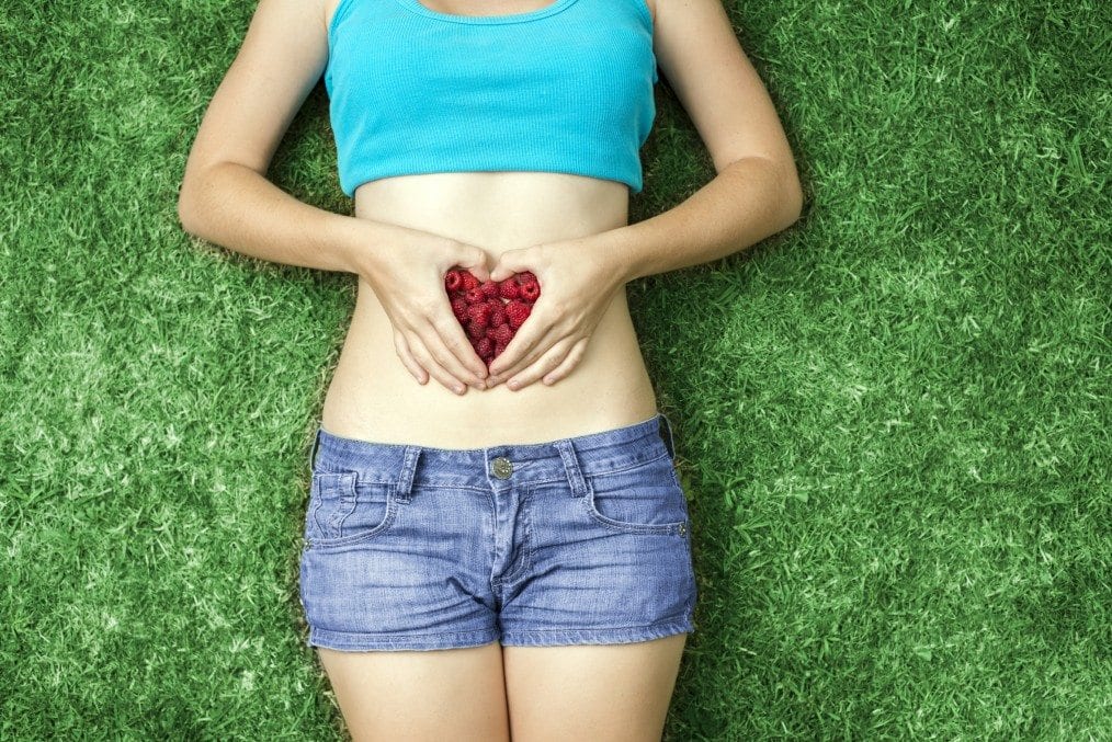 Girl with fruit on her gut area