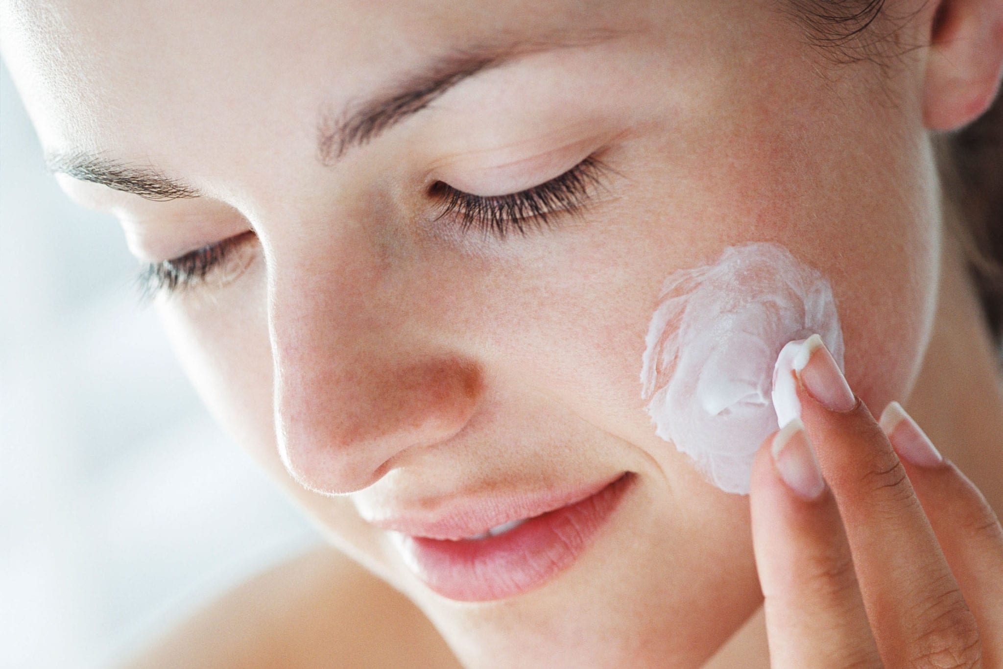 woman applying face cream