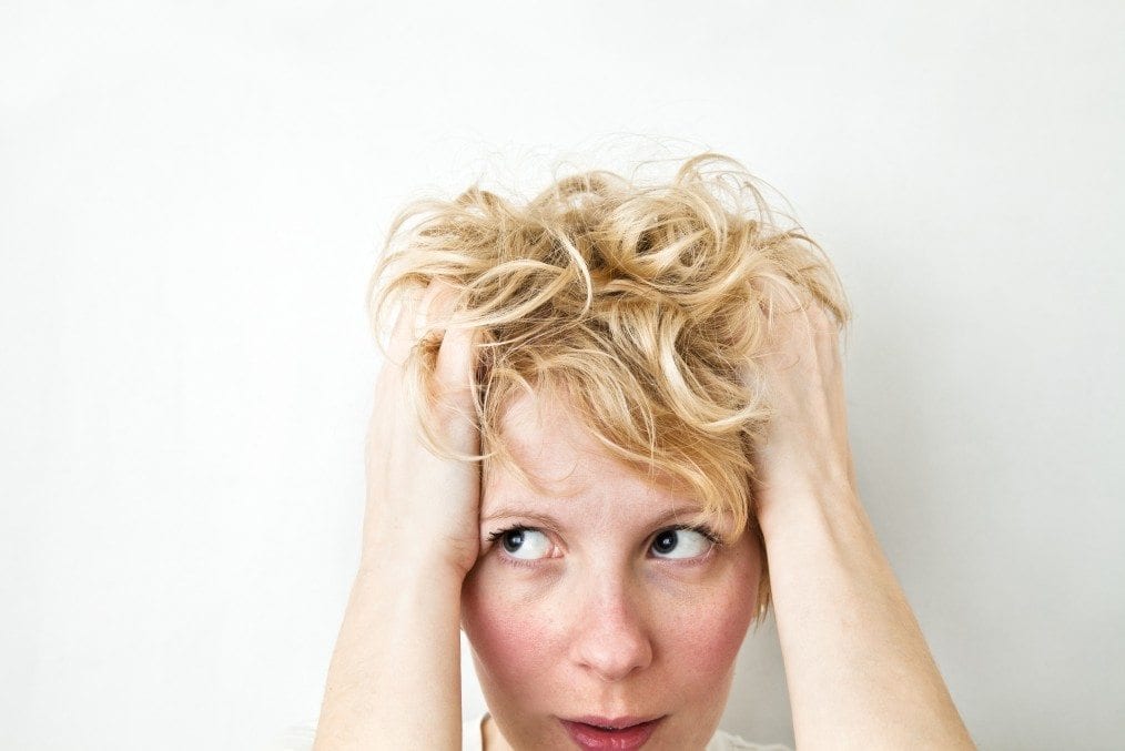 stressed woman holding hair
