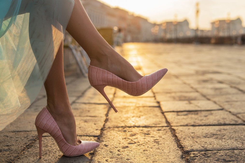 woman's feet in pink high heels