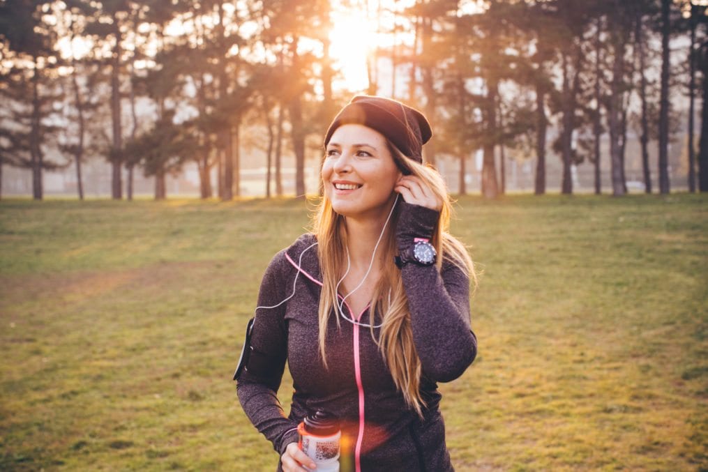 woman listening to music while jogging
