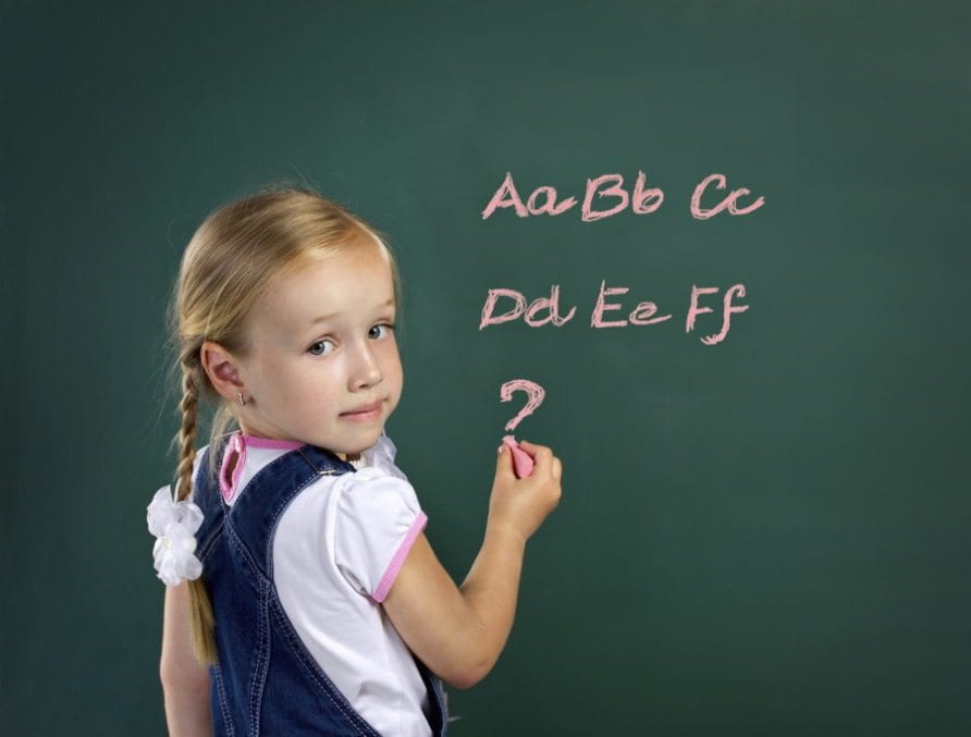 girl writing on blackboard