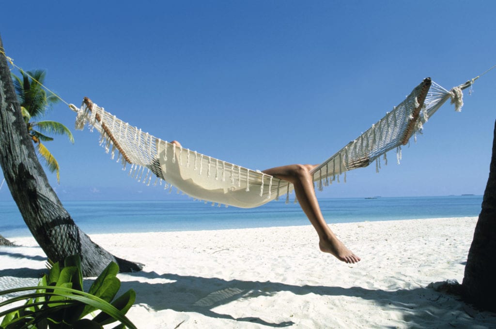 woman relaxing in a hammock on holiday