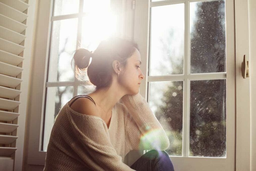 Woman looking out of a window