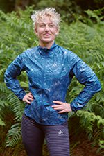 Endurance athlete Laura Try standing in a forest